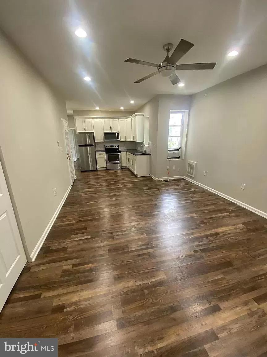 a view of a room with wooden floor