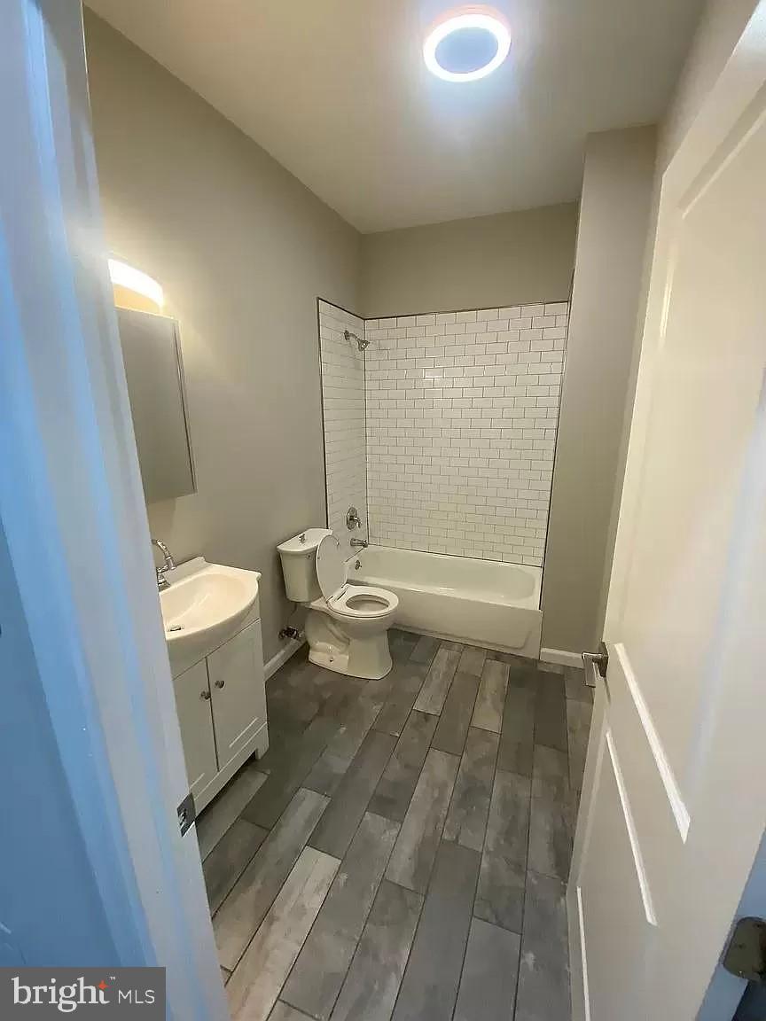 1470 North 52nd Street, Unit 2 Philadelphia, PA 19131 - Photo 7 of 8 a bathroom with a sink a toilet and a shower
