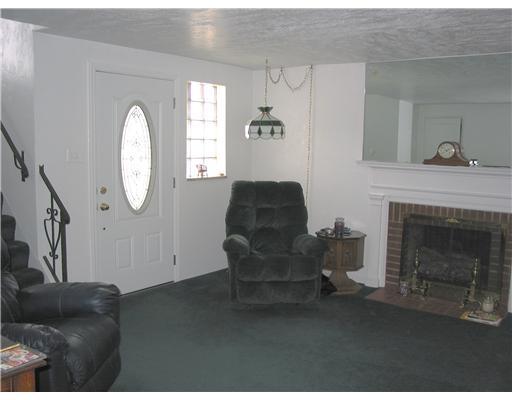 4314 Highgrove Road Whitehall, PA 15234 - Photo 3 of 8 Living Room. Attractive front door. Hardwood floors under wall to wall. Brick fireplace with hearth and mantel. Glass block window allows for lots of natural lighting.