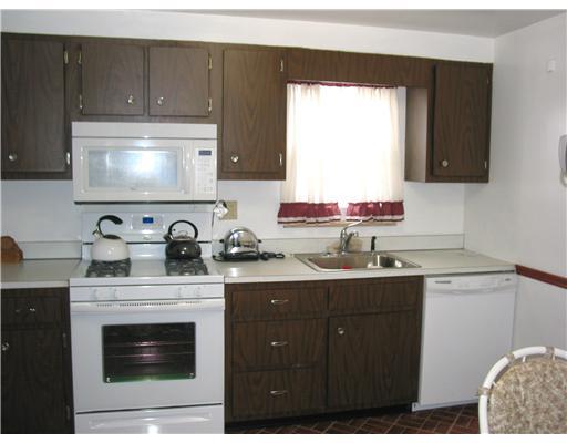 4314 Highgrove Road Whitehall, PA 15234 - Photo 8 of 8 Kitchen. Lots of cabinets and counter space. Room for a table for 2. Newer gas stove, microwave oven and dishwasher. Stainless steel sink. Door to basement from kitchen.