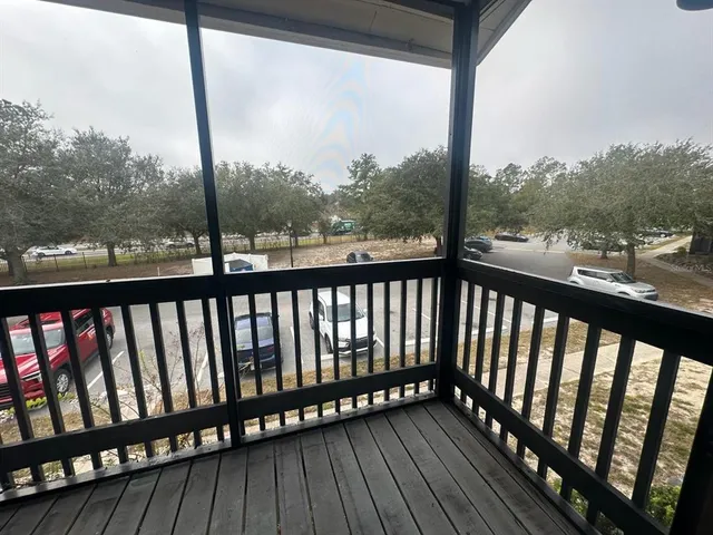 a view of a balcony with wooden floor