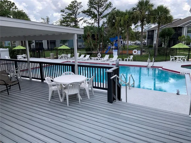a view of a chairs and table on the wooden deck