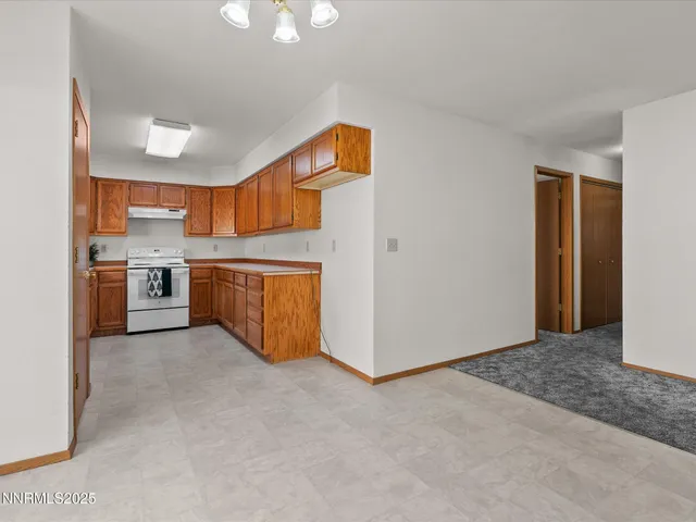 a view of a kitchen with a sink stove and a refrigerator
