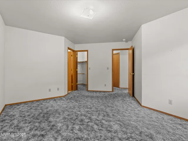 an empty room with closet area