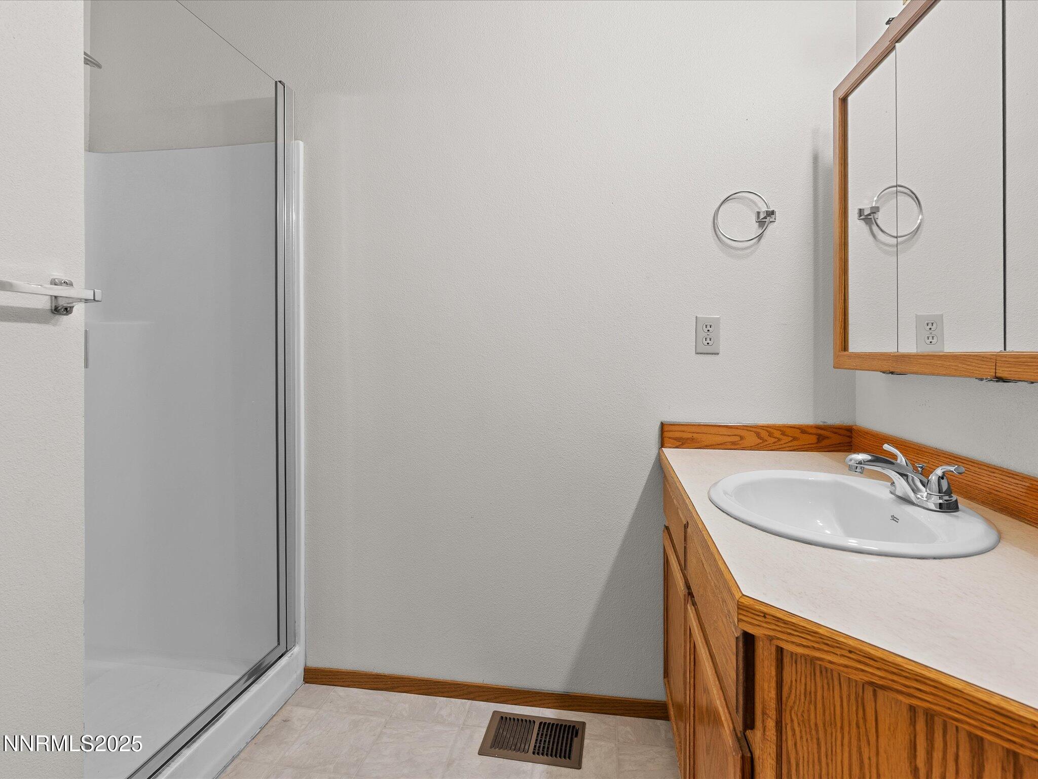 1951 Albert Street Fallon, NV 89406 - Photo 20 of 36 a bathroom with a sink a vanity and a mirror