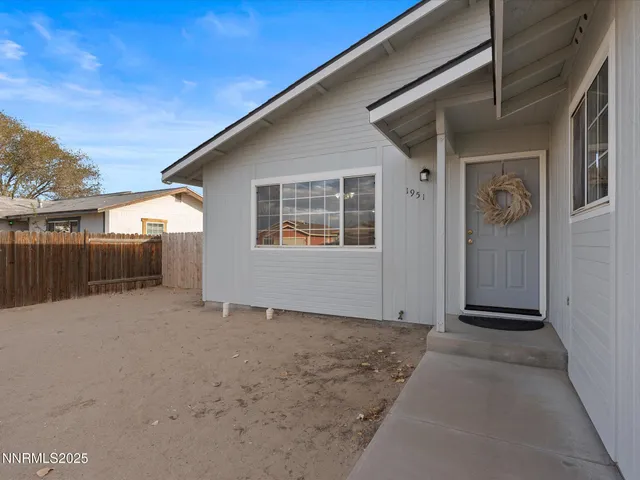 a view of a house with a wooden fence