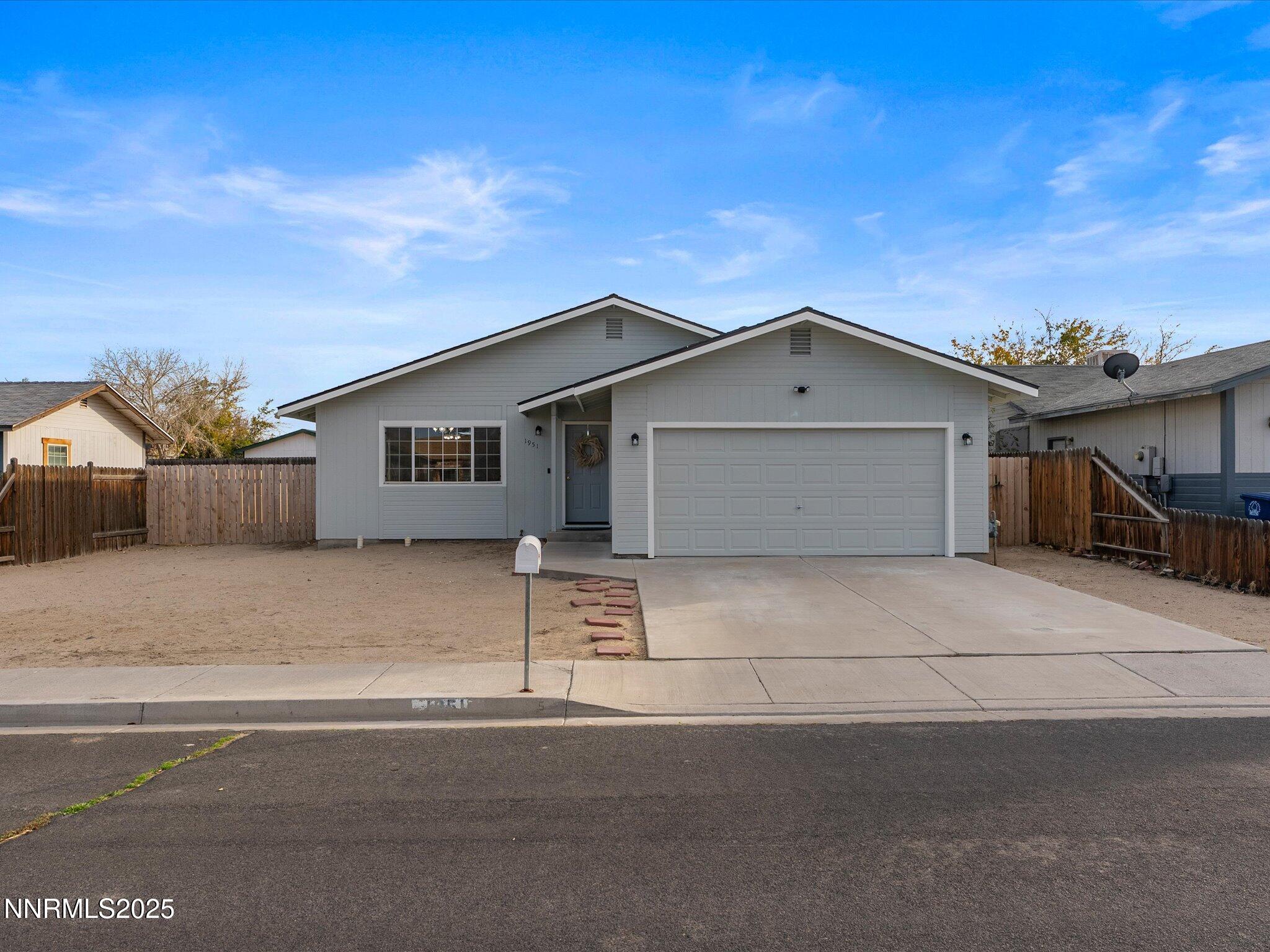 1951 Albert Street Fallon, NV 89406 - Photo 3 of 36 a front view of a house with a garage and wooden fence