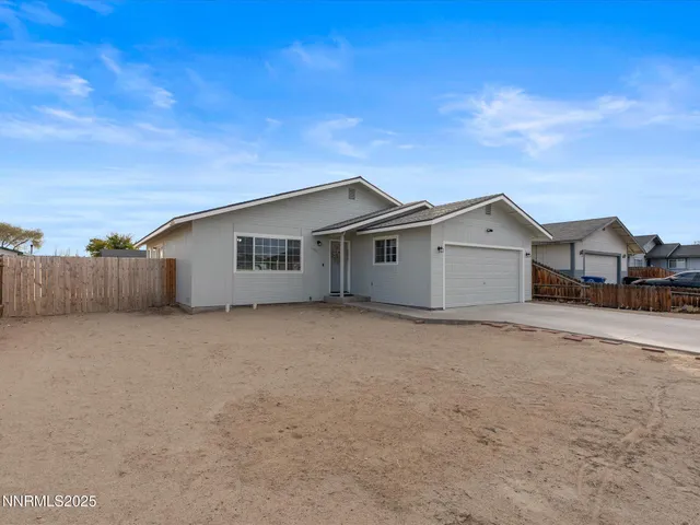 a view of house with garage and yard