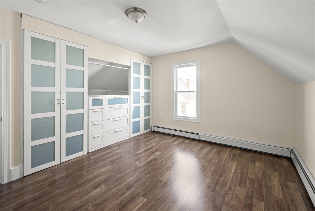 37 Union Street, Unit 2 Everett, MA 02149 - Photo 12 of 15 an empty room with wooden floor and windows