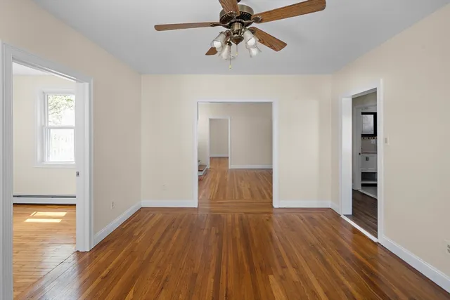 a view of a room with wooden floor closet and windows