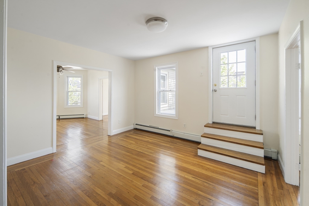 37 Union Street, Unit 2 Everett, MA 02149 - Photo 7 of 15 an empty room with wooden floor and windows