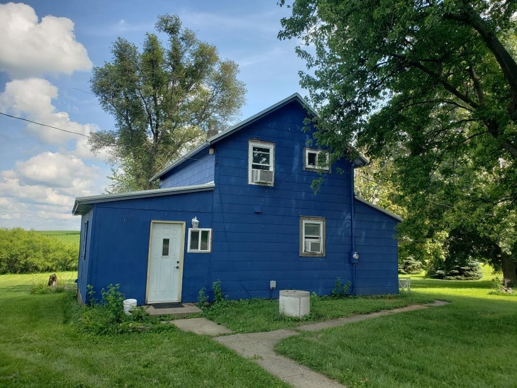a view of a brick house with a yard