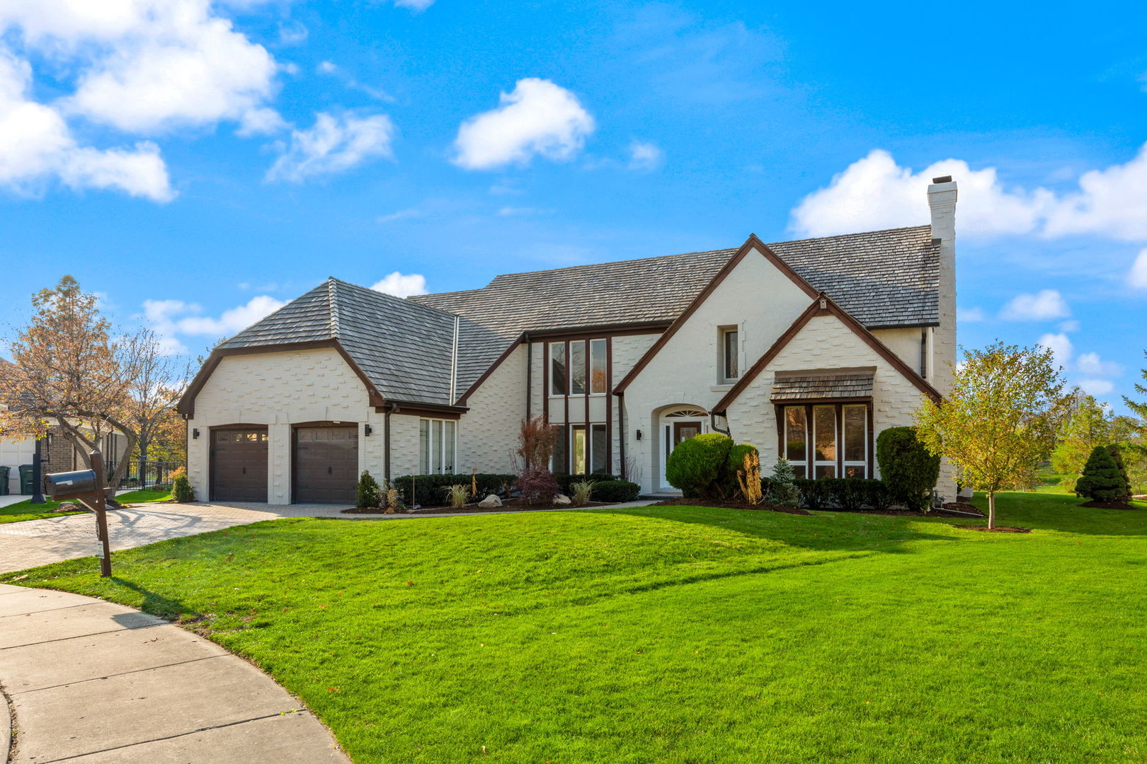 a front view of house with yard and green space