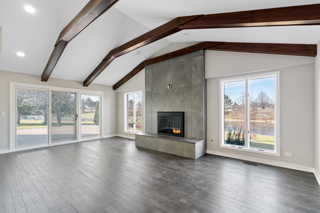 2500 Osage Drive Glenview, IL 60026 - Photo 19 of 77 an empty room with wooden floor fireplace and windows