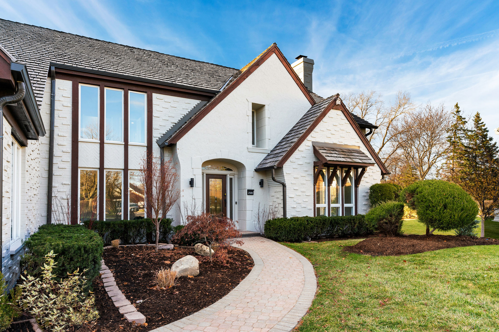 2500 Osage Drive Glenview, IL 60026 - Photo 2 of 77 a front view of a house with garden