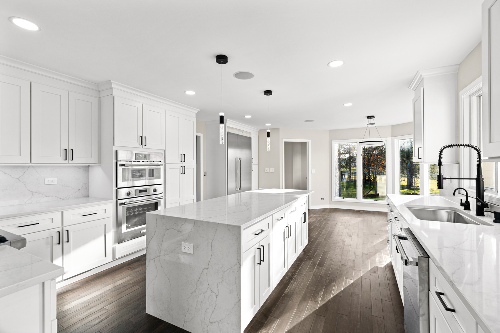 2500 Osage Drive Glenview, IL 60026 - Photo 29 of 77 a large kitchen with kitchen island a large counter top space a sink stainless steel appliances and cabinets