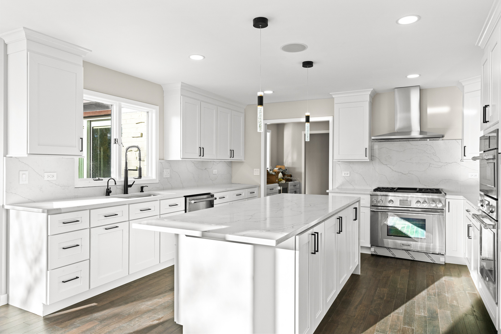 2500 Osage Drive Glenview, IL 60026 - Photo 30 of 77 a kitchen with kitchen island white cabinets and white appliances