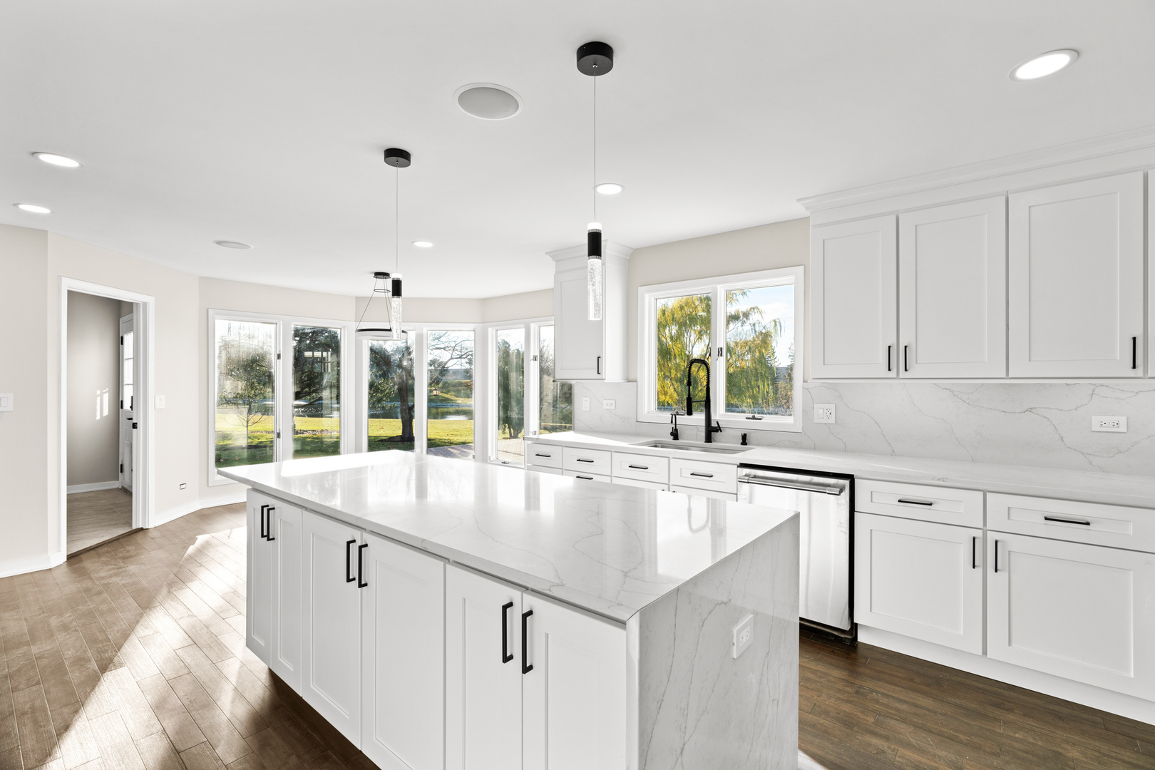 2500 Osage Drive Glenview, IL 60026 - Photo 33 of 77 a large white kitchen with kitchen island granite countertop a large window