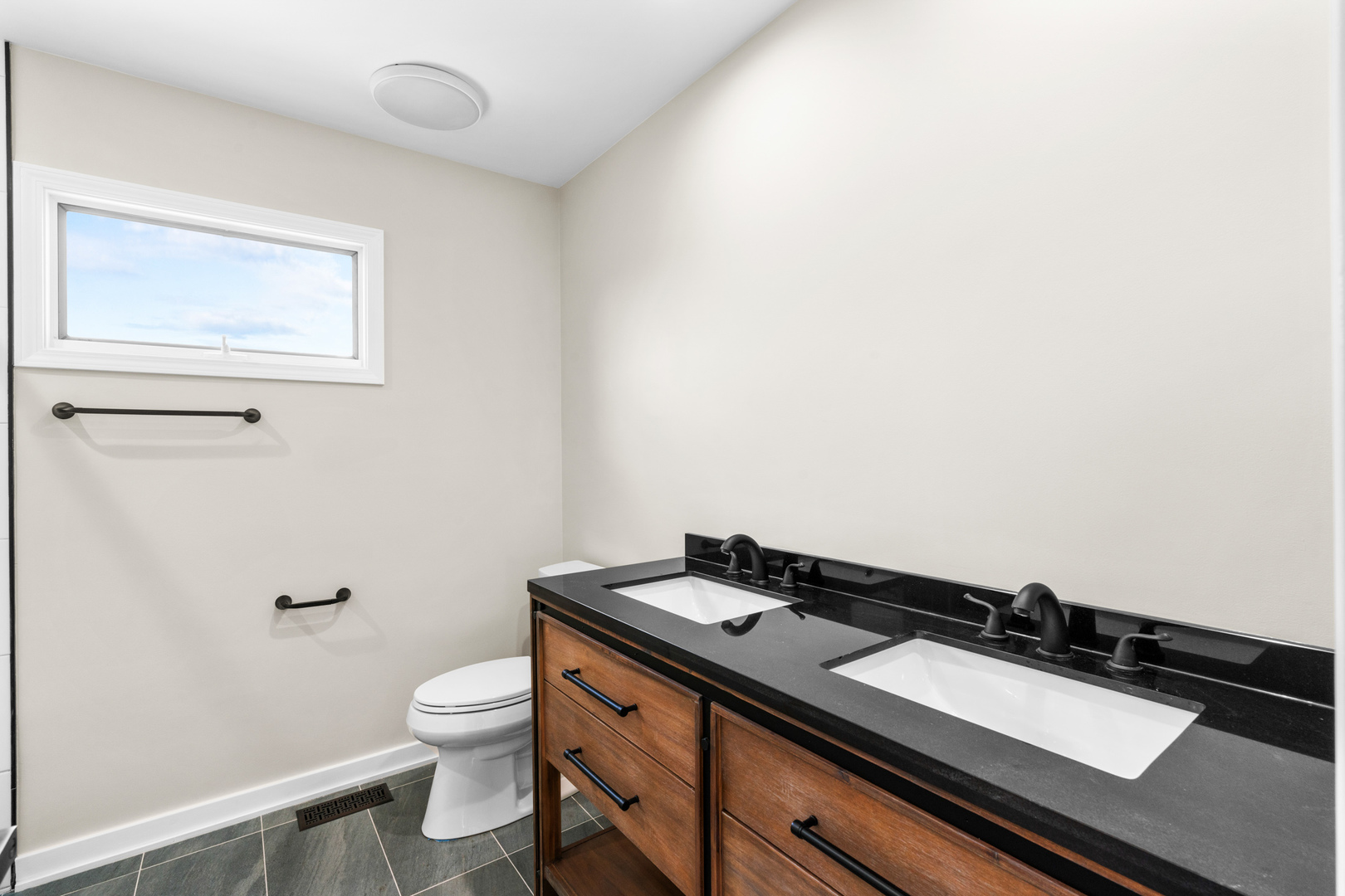 2500 Osage Drive Glenview, IL 60026 - Photo 38 of 77 a bathroom with a granite countertop sink toilet and a mirror