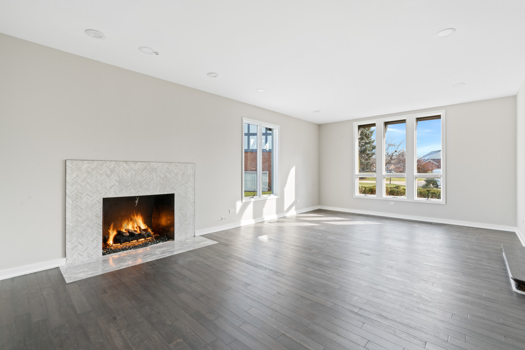 2500 Osage Drive Glenview, IL 60026 - Photo 47 of 77 a view of an empty room with wooden floor fireplace and a window
