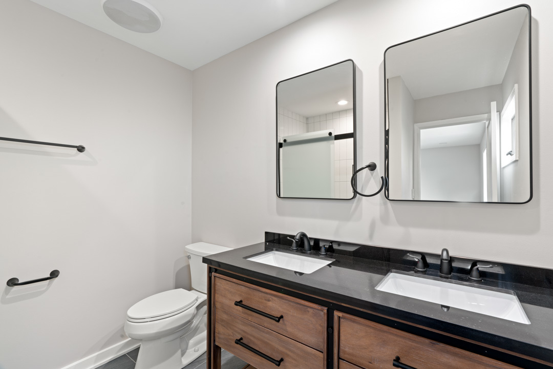 2500 Osage Drive Glenview, IL 60026 - Photo 68 of 77 a bathroom with a granite countertop toilet sink and mirror