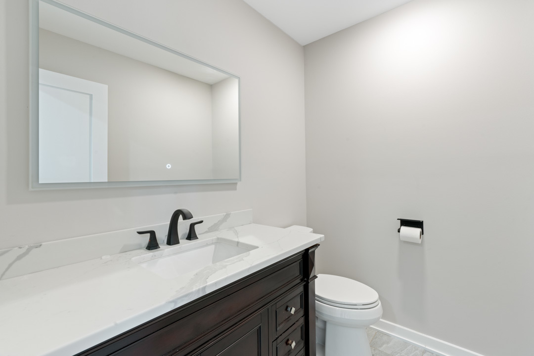 2500 Osage Drive Glenview, IL 60026 - Photo 74 of 77 a bathroom with a sink a toilet and mirror
