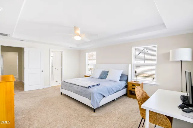 a bedroom with a bed couch and window