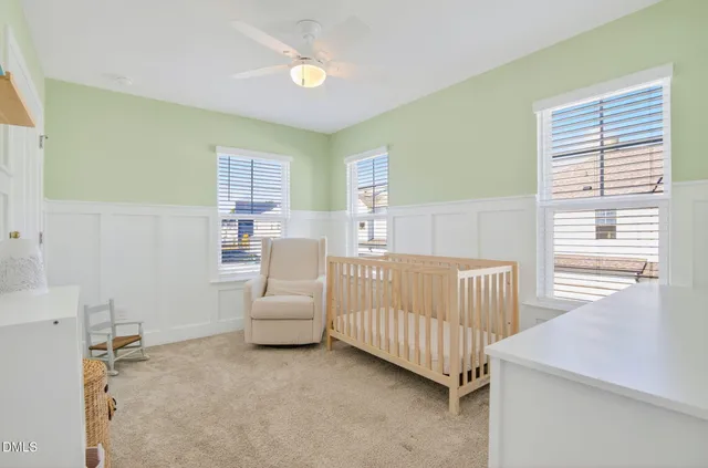 an empty room with white cabinet and a bathroom