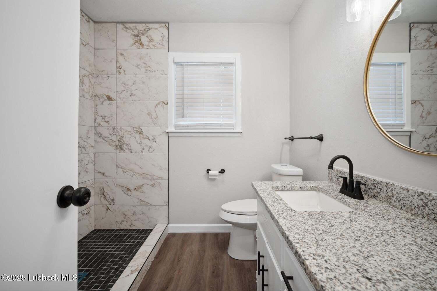 2004 45th Street Lubbock, TX 79412 - Photo 13 of 18 a bathroom with a sink and a mirror