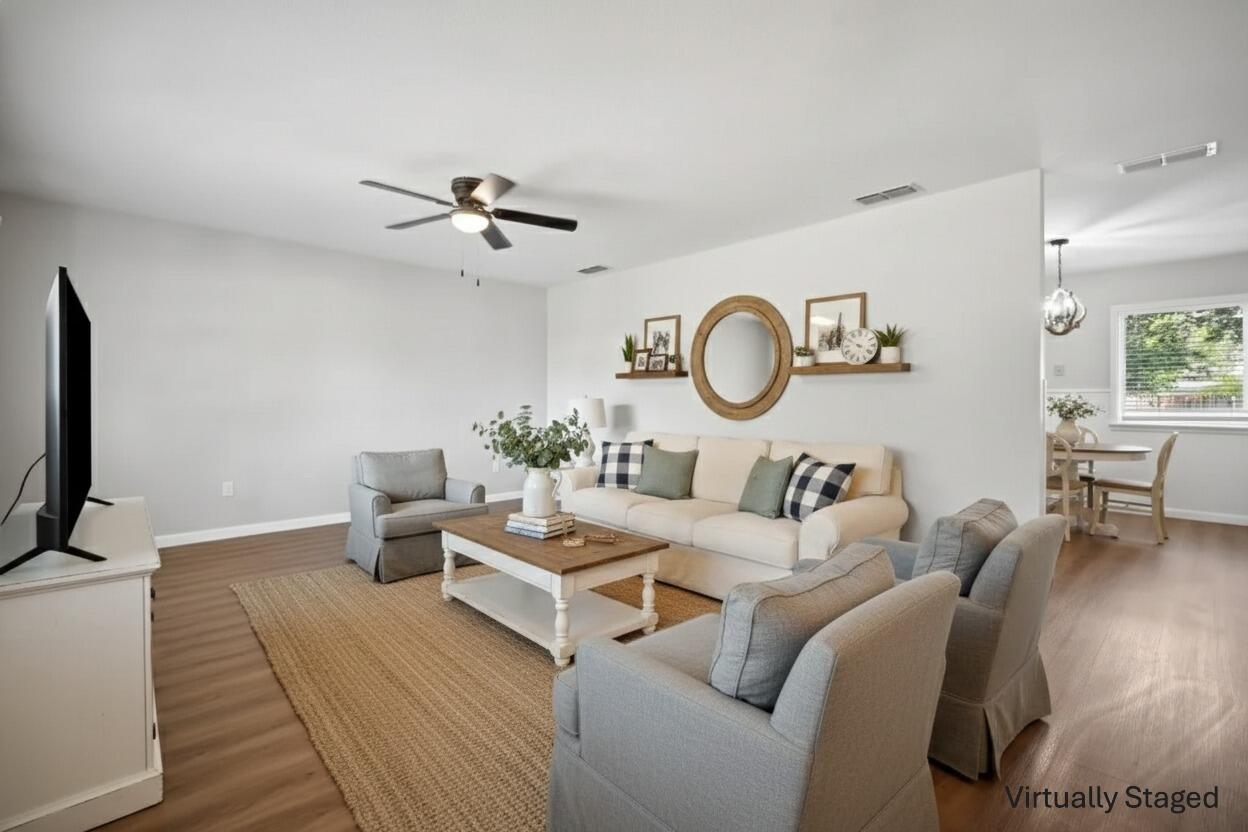 2004 45th Street Lubbock, TX 79412 - Photo 4 of 18 a living room with furniture a clock and a flat screen tv