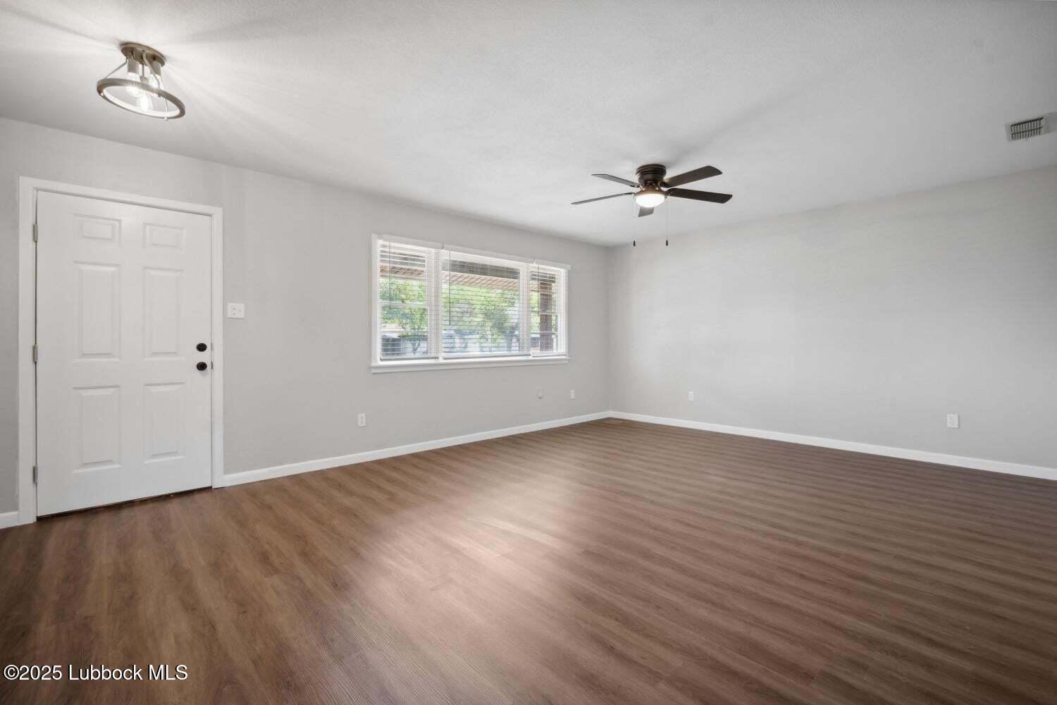 2004 45th Street Lubbock, TX 79412 - Photo 8 of 18 wooden floor in an empty room with a window