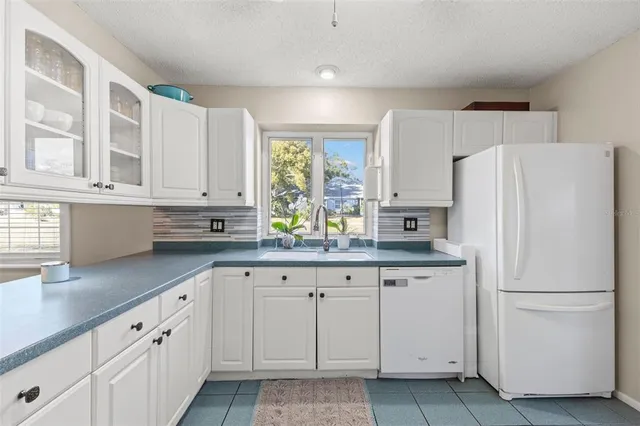 a white refrigerator freezer sitting inside of a kitchen