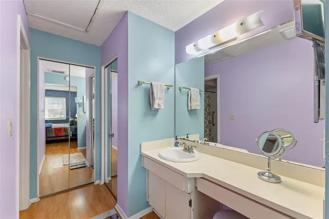 a bathroom with a sink vanity and mirror