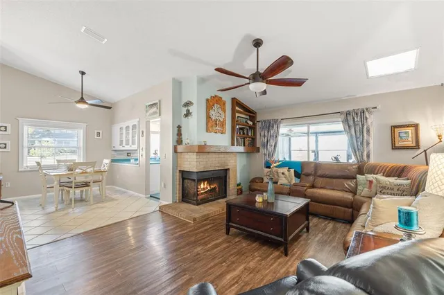 a living room with furniture a fireplace and a window