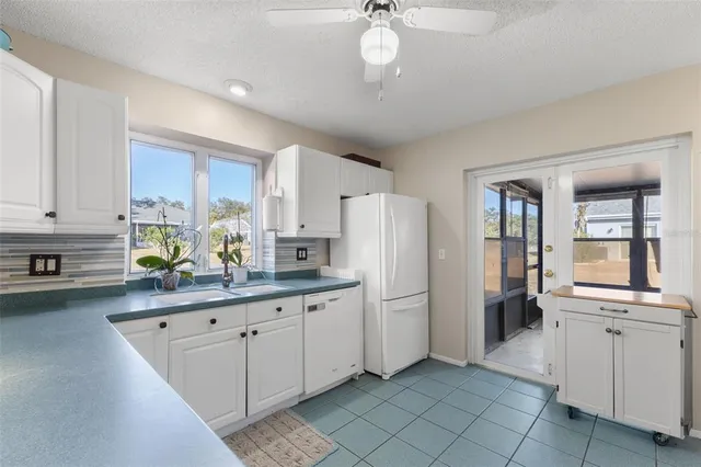 a kitchen with refrigerator and cabinets