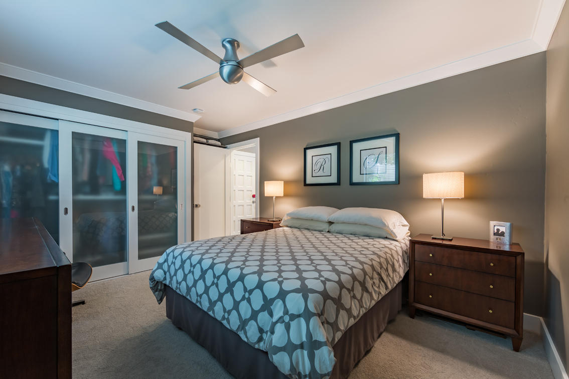 3375 Foothill Road, Unit 213 Carpinteria, CA 93013 - Photo 13 of 25 a bedroom with a bed a lamp and a chandelier