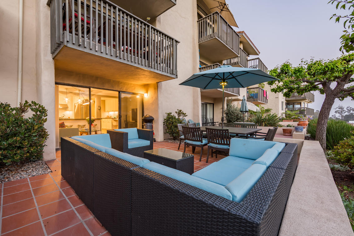 3375 Foothill Road, Unit 213 Carpinteria, CA 93013 - Photo 16 of 25 a view of a patio with couches and table and chairs with potted plants