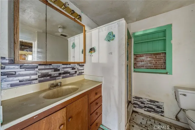 a bathroom with a sink a vanity and a mirror