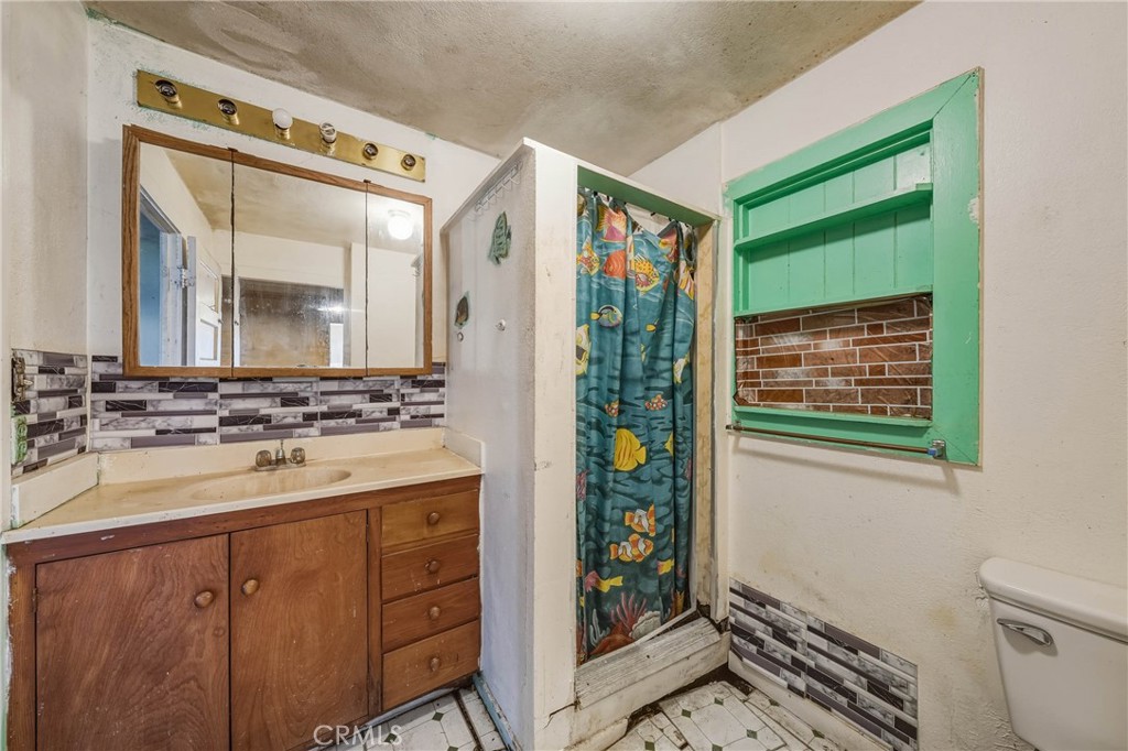 3527 Highway 20 Nice, CA 95464 - Photo 13 of 29 a bathroom with a sink a vanity and a mirror