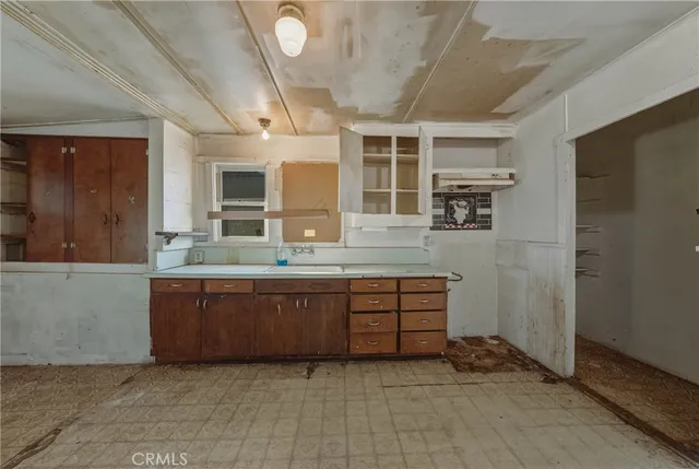 a kitchen with sink cabinets and window