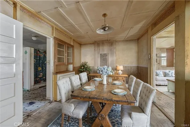 a view of a livingroom with an empty space and a kitchen
