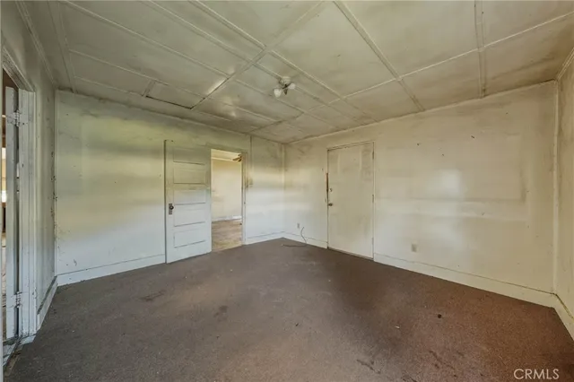 a bedroom with a bed and a dresser in it