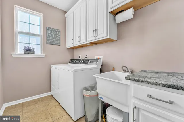 a utility room with a sink dryer and washer