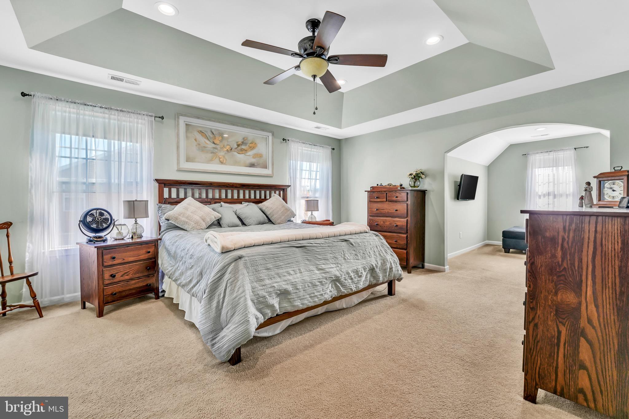 63 Homestead Drive Pemberton, NJ 08068 - Photo 24 of 46 a bedroom with a large bed and a chandelier