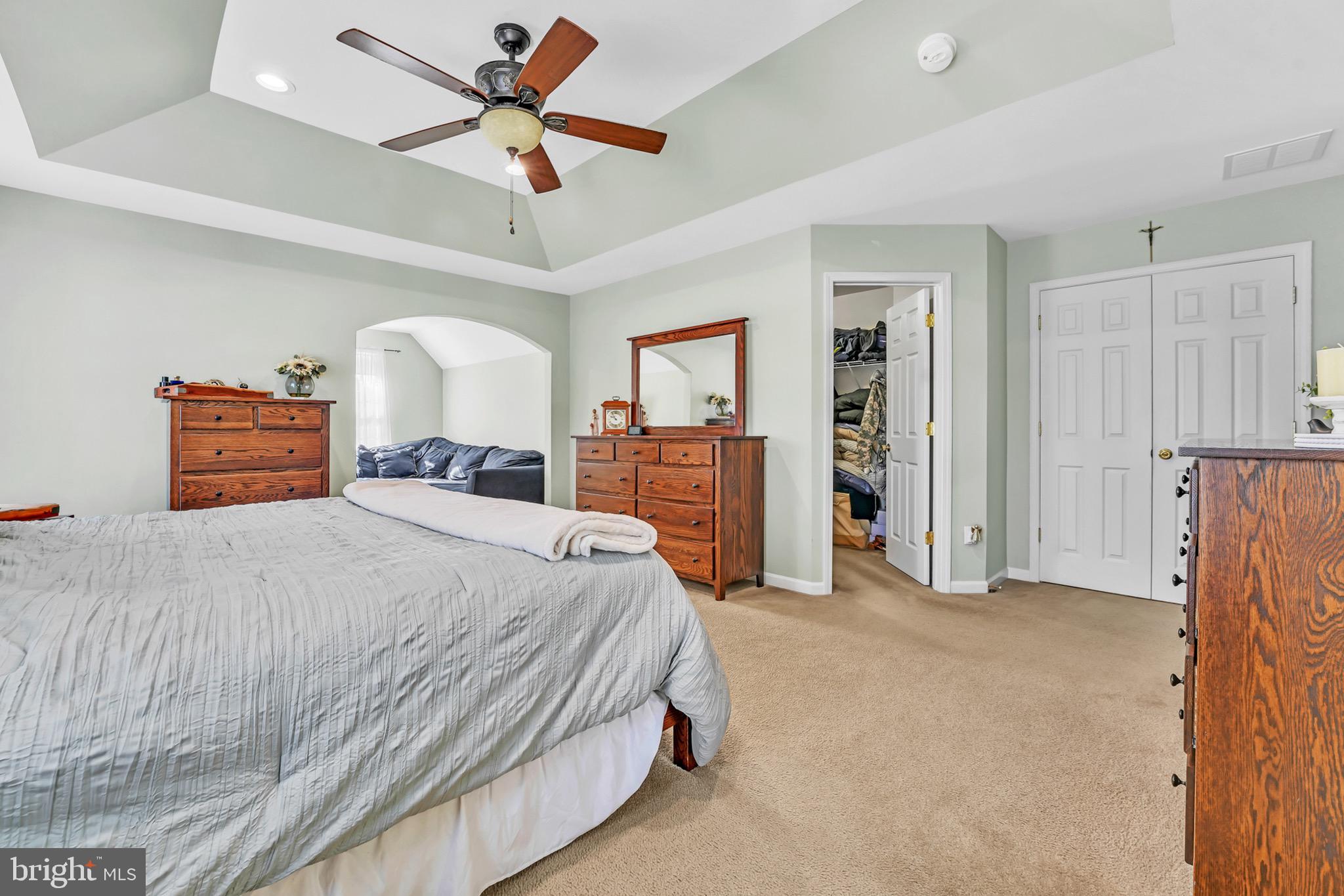 63 Homestead Drive Pemberton, NJ 08068 - Photo 25 of 46 a bedroom with a large bed and a chandelier