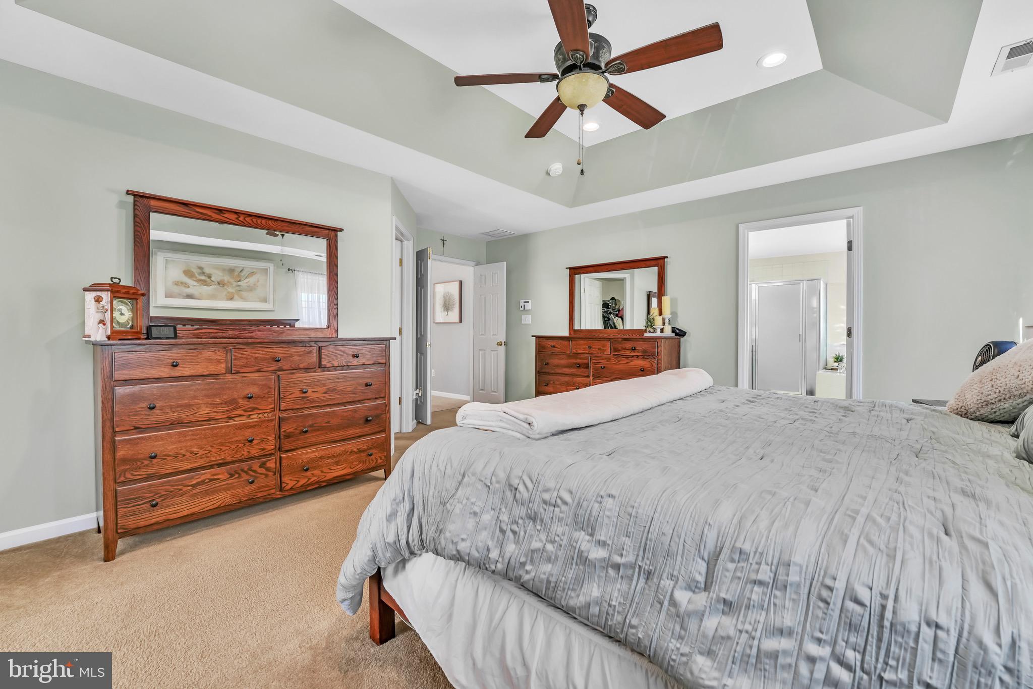 63 Homestead Drive Pemberton, NJ 08068 - Photo 26 of 46 a bedroom with a bed and a chandelier