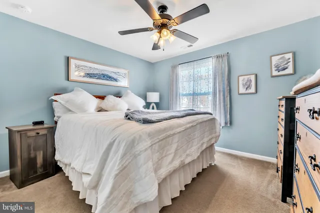a bedroom with bed and a chandelier