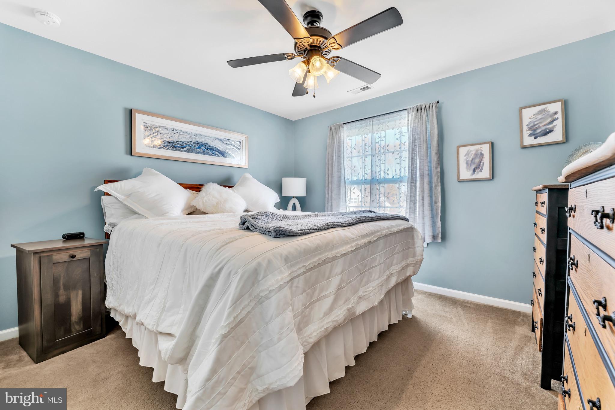 63 Homestead Drive Pemberton, NJ 08068 - Photo 29 of 46 a bedroom with bed and a chandelier