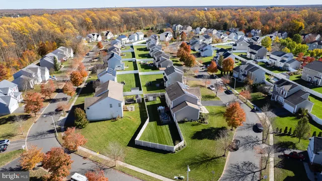 an aerial view of a house with a swimming pool