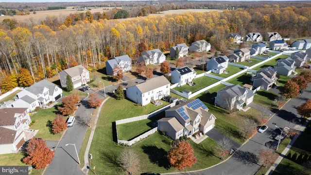 an aerial view of a house with a swimming pool